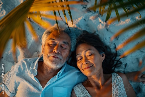 Close-up of an Asian elderly couple experiencing the closeness and warmth of love while laying side by side on a bed.