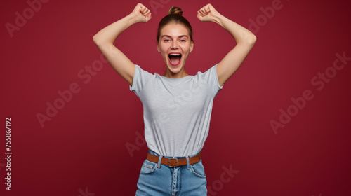 jubilant woman with her arms raised in a celebratory victory pose © MP Studio