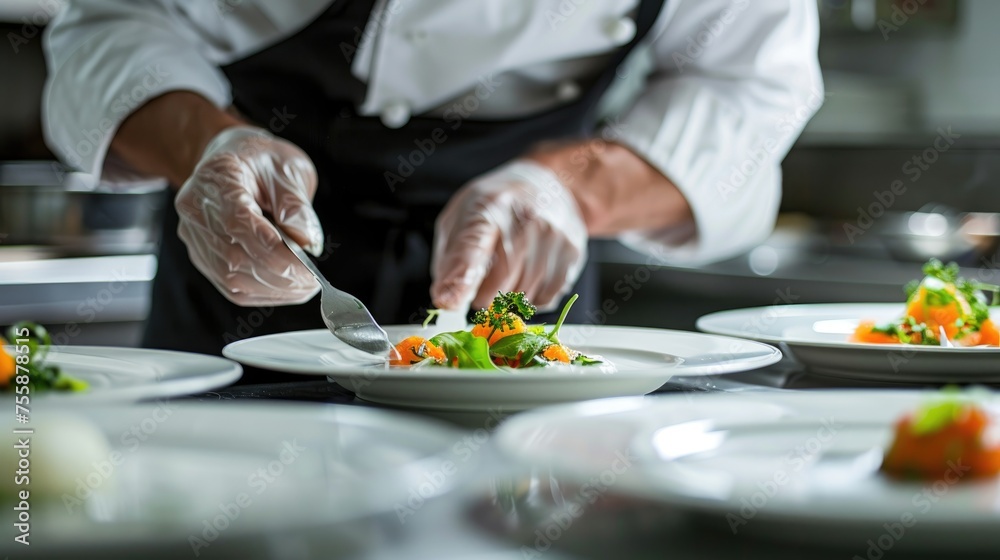 A professional chef carefully garnishes a gourmet dish with delicate precision, perfecting the presentation in a high-end restaurant.
