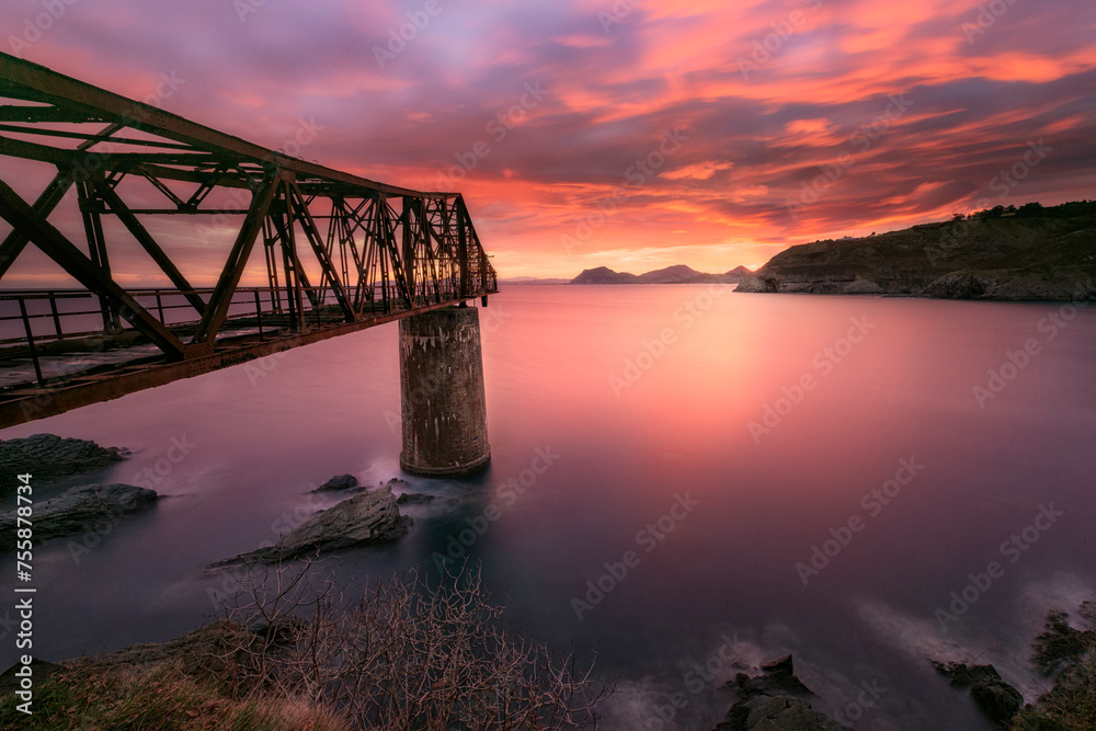 Fototapeta premium Sunrise from Dicido beach, Mioño, Castro Urdiales, with a cloudy sky with dramatic tones and warm colors