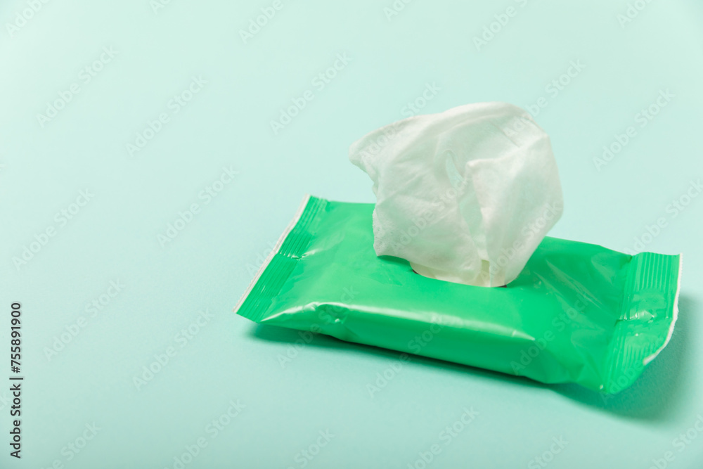 Naklejka premium Packaging of wet wipes on a colored background. An open pack of hand and body wipes. Mockup. A clean packet of wet wipes. Design. Place for text. Copy space.