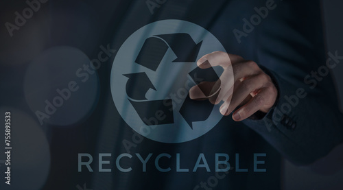 Man hand touch a recycle logo on a virtual screen. Circular economy, recycling and reuse concept