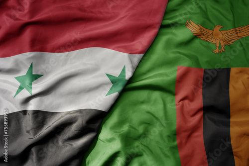 big waving national colorful flag of zambia and national flag of syria .