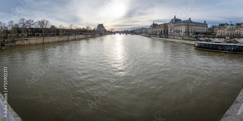 Paris, France - 03 08 2024: View of the quayside of the Seine and the Orsay museum facadefrom the Leopold-Sedar-Senghor footbridge. photo