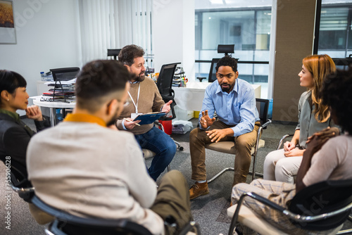 Group of people sitting in a circle are participating in a support meeting. Healthcare and medicine concept.