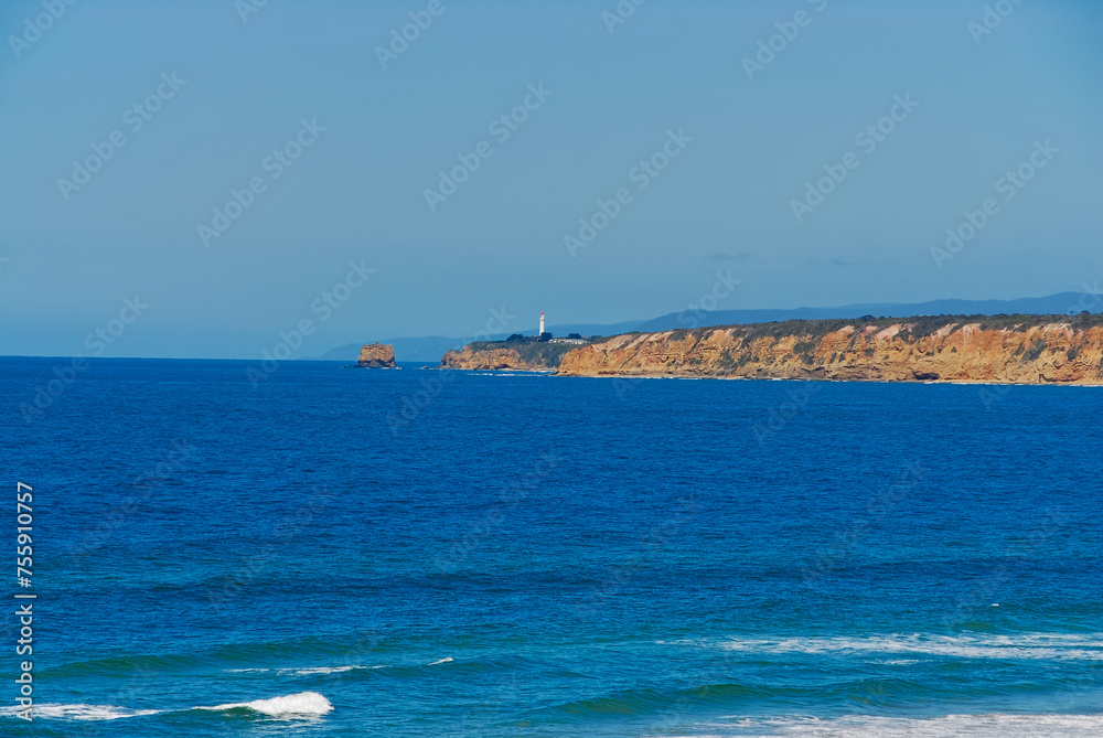 A view of a lighthouse on a clear sunny day along the Great Ocean Road in southern Victoria, Australia.