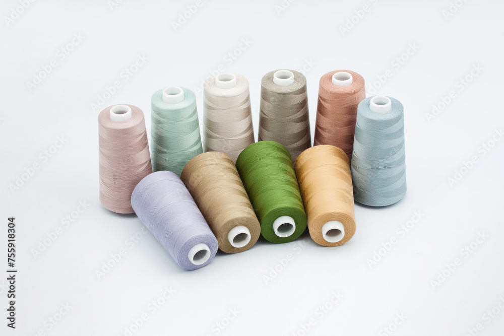 Thread spools background. Various colors sewing kit. Collection of threads. Pale pastel colors. Sew threads. Colorful hobby background. Tailor shop texture. Isolated on white. Thread spools background. Various colors sewing kit. Collection of threads. Pale pastel colors. Sew threads. Colorful hobby background. Tailor shop texture. Isolated on white.