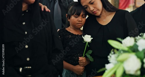 Funeral, family and woman with child at coffin with flower at memorial service at church in respect, support and comfort. Death, grief and widow with daughter, rose and goodbye at casket for farewell photo