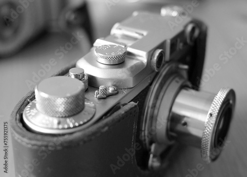 Vintage camera on the table. Selective focus. Black and white.