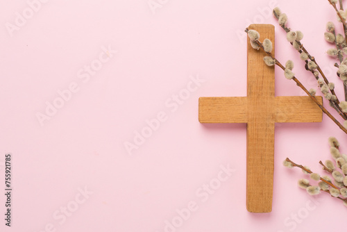 Cross with willow branches on color background, top, view. Palm Sunday concept photo