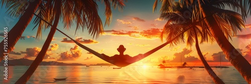 Silhouette of person relaxing on hammock at sunset - A tranquil beach scene capturing a person's silhouette on a hammock between palm trees against a sunset backdrop photo