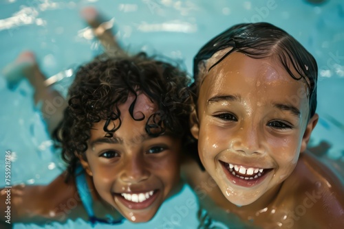 young kids at a swimming pool smiling at the camera