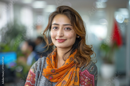 Attractive Nepali woman standing in office. Smiling businesswoman. photo