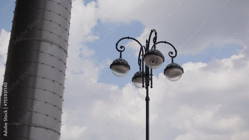 A lantern in the city against the sky next to a stone column. Shooting of urban architecture A lantern in the city against the sky next to a stone column. Shooting of urban architecture