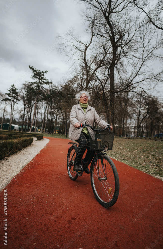 Mature female retiree outdoors with her bicycle on a scenic park pathway, exemplifying an active lifestyle and leisure activity.