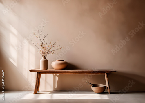 Rustic wooden bench and clay vase with branch near beige grunge stucco wall with copy space. Japandi, wabi-sabi home interior design of modern living room.