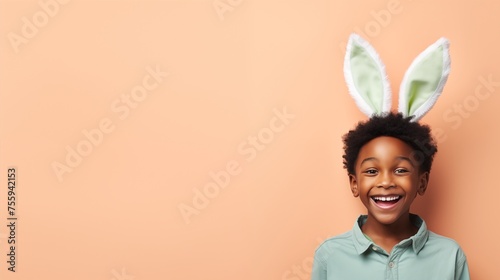 black boy with bunny ears smiling on studio background photo