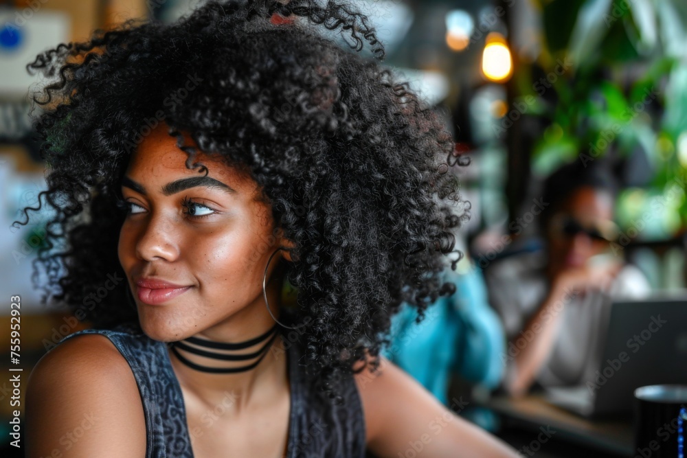 Young Woman With Curly Hair Smiling Inside a Busy Cafe During Daytime Young Woman With Curly Hair Smiling Inside a Busy Cafe During Daytime