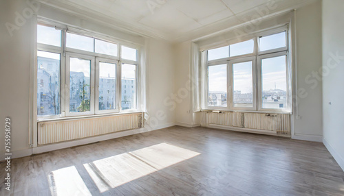 an empty room with wood flooring and white paint on the walls there is a large window in the corner. Copy space image. Place for adding text or design