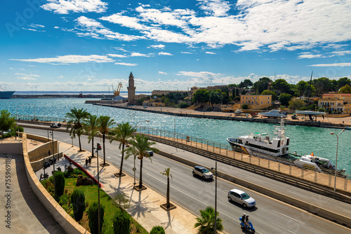 Urban road and port with lighthouse in Palma de Mallorca, Spain.