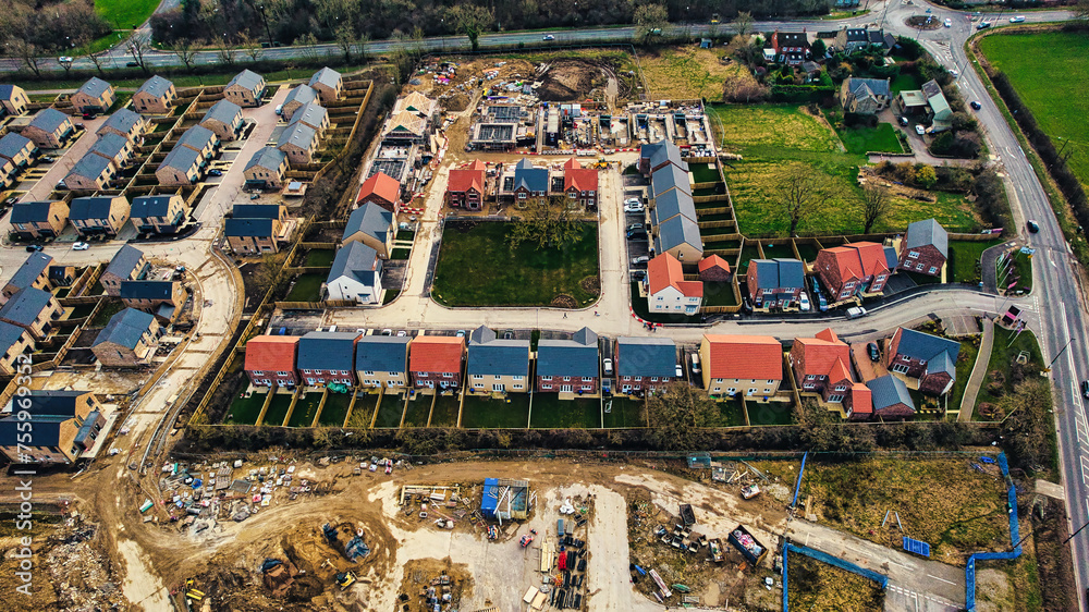 Fototapeta premium Aerial view of a residential construction site with partially completed houses and infrastructure development in Harrogate, North Yorkshire.