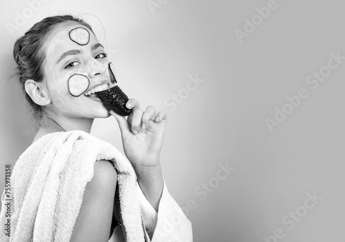 Healthy and beautiful. Girl chilling making clay facial mask with cucumber. Skin health. Woman adorable smiling girl with clay mask. Cleaning and care for young skin. Proper approach to clean skin