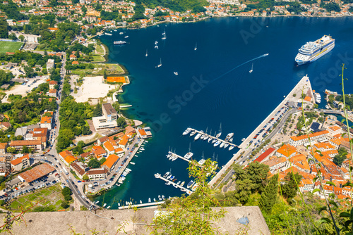 Aerial view of marina in Kotor bay and old town from Lovcen Mountain, Montenegro. Adriatic fjord with yachts and cruise ship in summer day. Travel destination