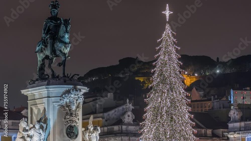 Commerce square illuminated and decorated at Christmas time in Lisbon night timelapse. Commercio square with Christmas tree and Jose I monument. People tourists crowd around. Holiday times. Portugal