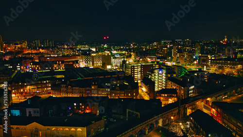 Night cityscape with illuminated buildings and streets, showcasing urban architecture and nightlife in Leeds, UK.