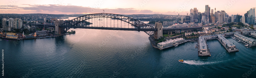Panoramic aerial view of Sydney Harbour Bridge, Sydney Harbour and Sydney City, NSW Australia during an early morning sunrise in March 2024