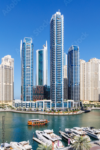 Dubai Marina skyline cityscape with yachts skyscraper buildings living at water portrait format