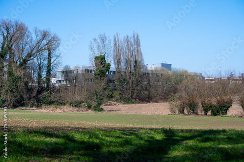 Zellik, Flemish Brabant, Belgium  - Hills and farmland with industrial buildings in the background photo