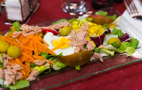 Fresh salad with vegetables, lettuce and marinated tuna at plate