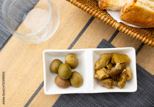 Appetizing pickled green olives and chopped eggplant marinated with garlic and spices. Typical mediterranean vegetable tapa ..