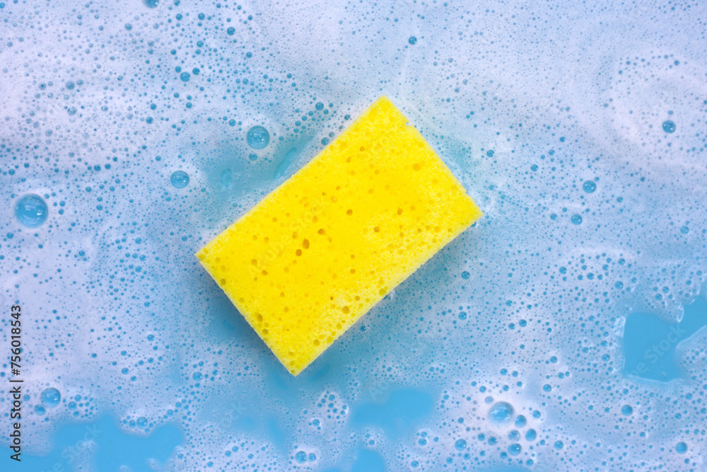 Cleaning sponge in foam of dishwashing liquid. Washing dishes concept Cleaning sponge in foam of dishwashing liquid. Washing dishes concept