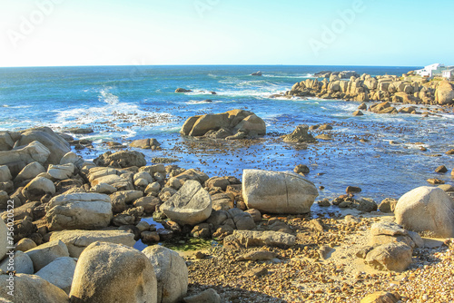 Coastal landscape with rocky beach and blue sky in Atlantic Ocean. Cape Town, Western Cape, South Africa.