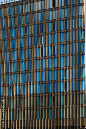 Modern office building facade with blue glass windows and steel structure, architectural background in Liverpool, UK.