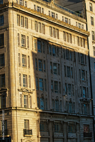 Sunlight casting shadows on a classic urban building facade during golden hour, highlighting architectural details in Liverpool, UK.