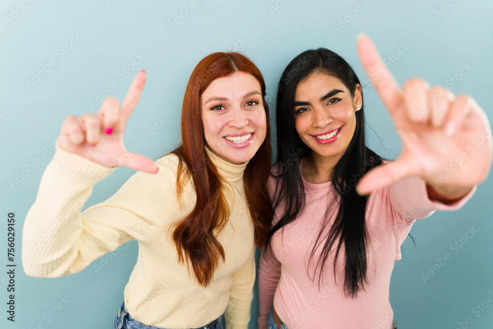Excited women best friends taking pictures together Excited women best friends taking pictures together