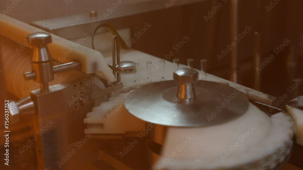 fire ampoule making. vaccine glass tube ampoule vial injection making process using fire in a pharmaceutical production line factory. medicine in a healthcare manufacturing facility. medical drug fire ampoule making. vaccine glass tube ampoule vial injection making process using fire in a pharmaceutical production line factory. medicine in a healthcare manufacturing facility. medical drug