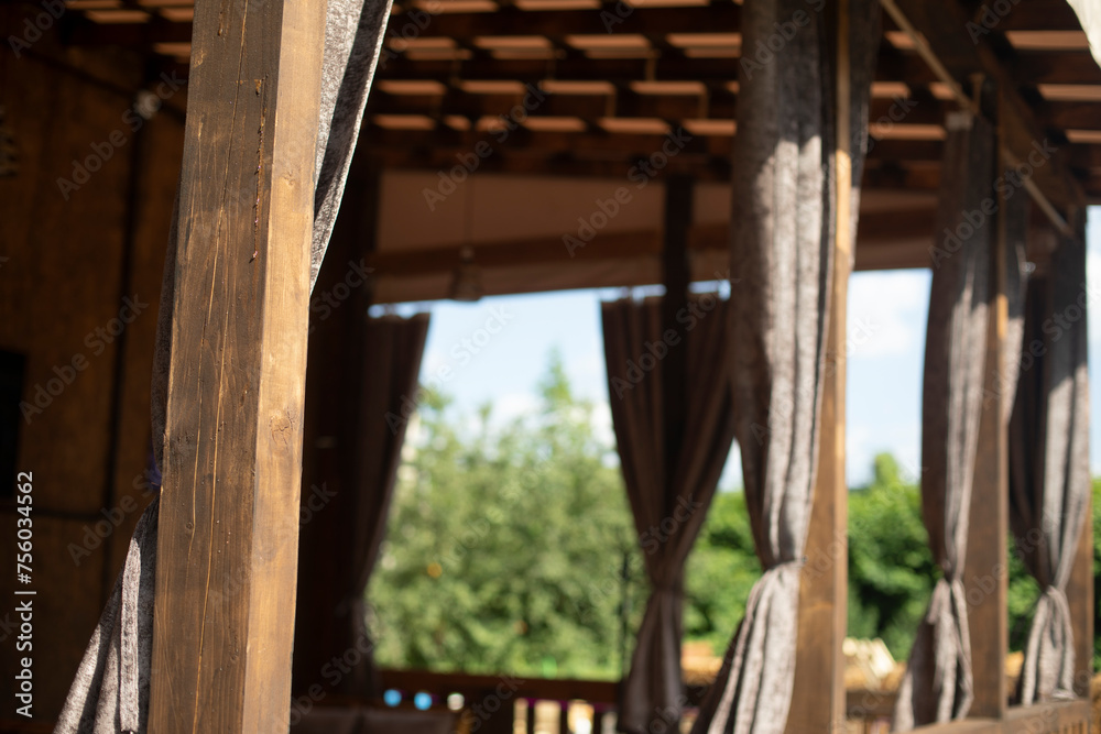 Curtains in restaurant. UPrivate Restaurant. Interior is made of wood.