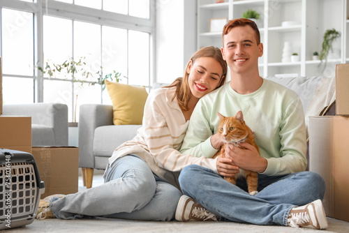 Young couple with cute cat ...