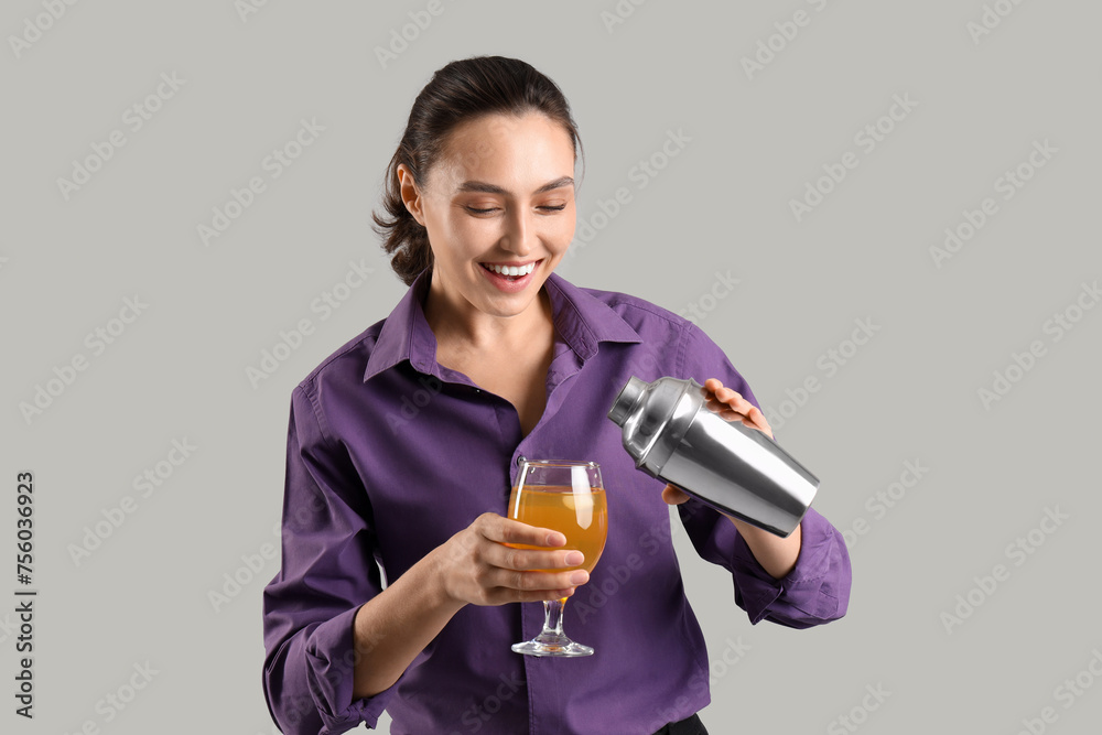 Female bartender with cocktail and shaker on light background Female bartender with cocktail and shaker on light background