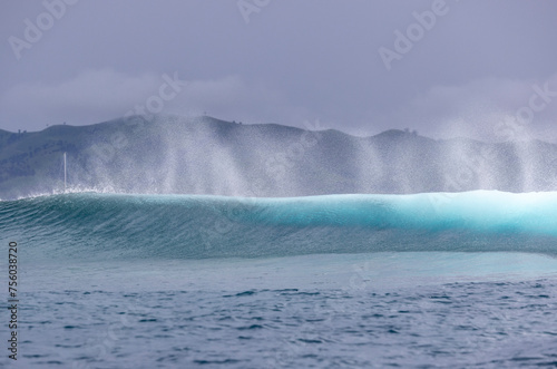 Ocean wave spray from behind a wave