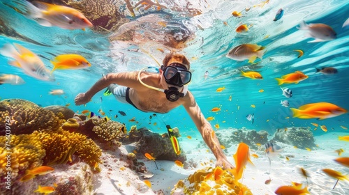 male scuba diver, swimming underwater, under tropical sea clear blue, Colorful coral reef, underwater and the seabed, snorkeling amongst many exotic fish