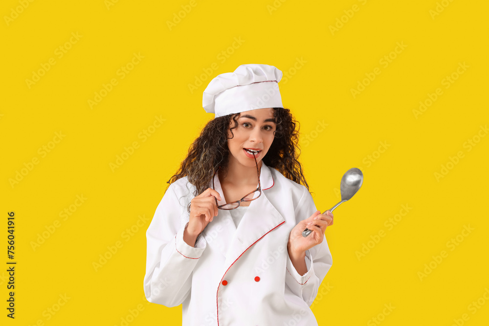 Female African-American chef with eyeglasses and ladle on yellow background Female African-American chef with eyeglasses and ladle on yellow background