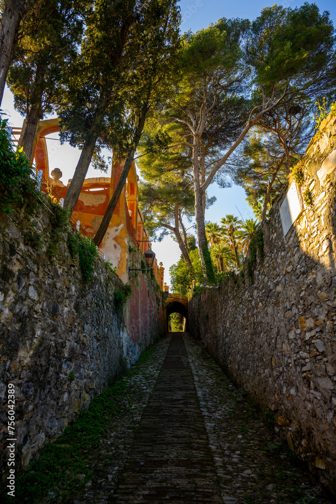 Sunlit Historic Alleyway with Stone Arch in Santa Margherita Ligure