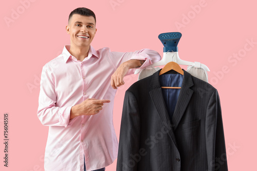 Happy young man pointing at...