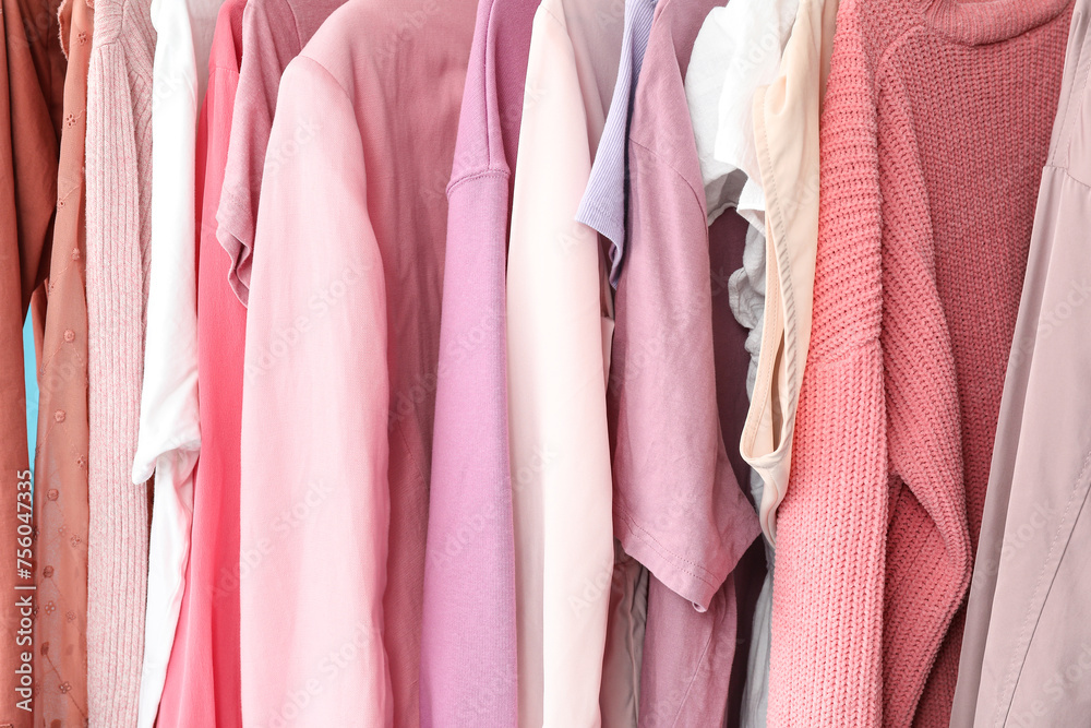 Stylish clothes hanging on rack, closeup Stylish clothes hanging on rack, closeup