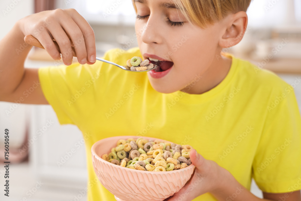 Cute little boy eating cereal rings at home Cute little boy eating cereal rings at home